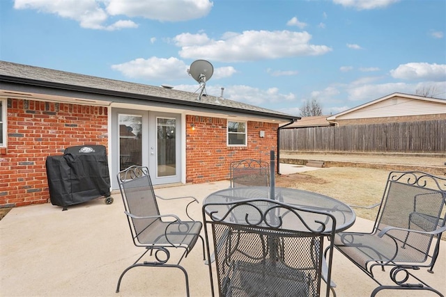 view of patio / terrace with outdoor dining space, french doors, fence, and grilling area