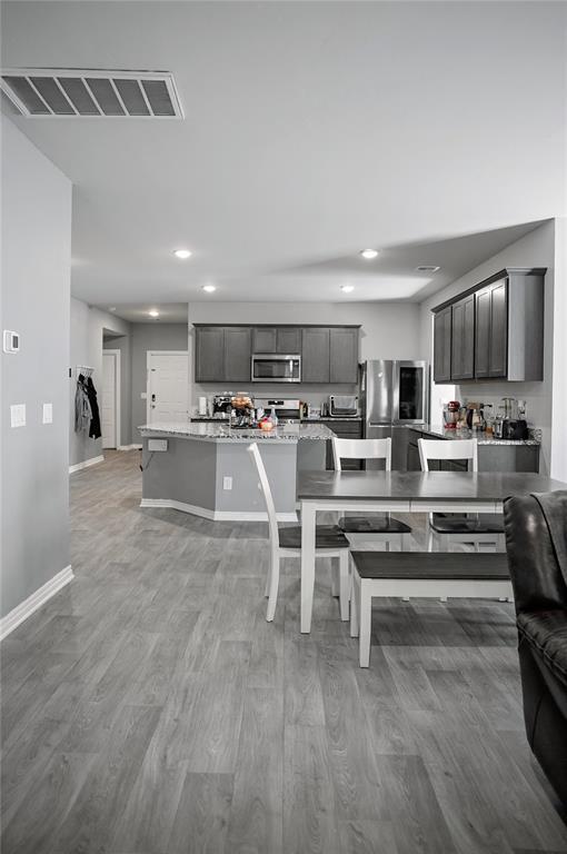 interior space featuring light wood-style floors, baseboards, visible vents, and recessed lighting