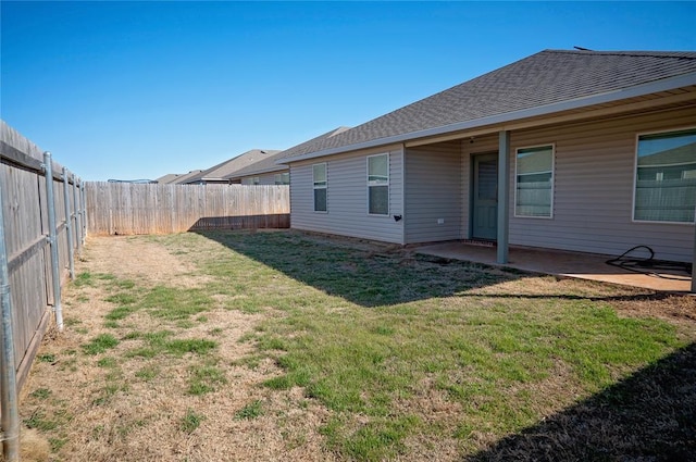 view of yard featuring a patio area and a fenced backyard