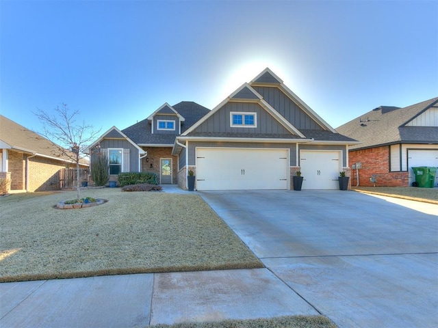 craftsman-style house featuring an attached garage, board and batten siding, and driveway