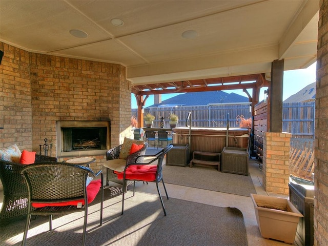 view of patio / terrace featuring an outdoor living space with a fireplace and fence