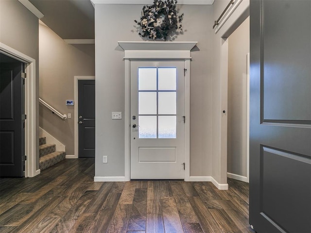 foyer featuring stairway, dark wood-style floors, and baseboards