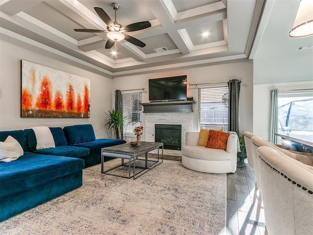 living room featuring visible vents, coffered ceiling, beam ceiling, a fireplace, and crown molding