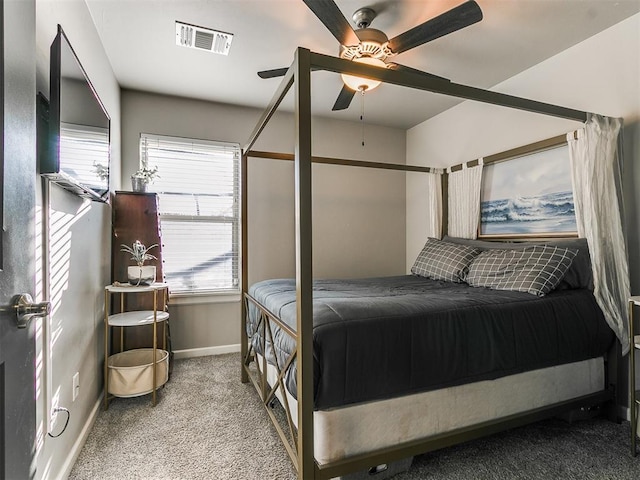 carpeted bedroom with baseboards, visible vents, and ceiling fan