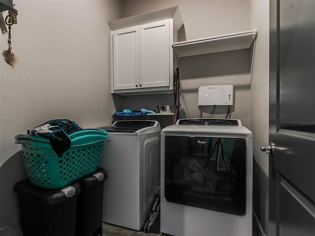 laundry room featuring cabinet space and washing machine and dryer