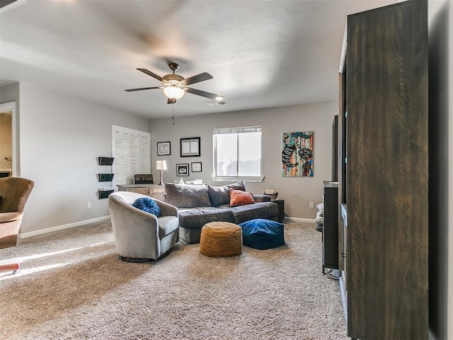 living area featuring visible vents, baseboards, light colored carpet, and a ceiling fan