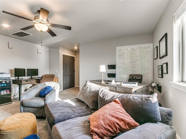 living room featuring visible vents, baseboards, a ceiling fan, and carpet floors