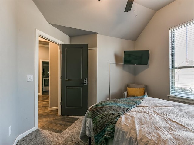 carpeted bedroom featuring a closet, baseboards, lofted ceiling, and a ceiling fan