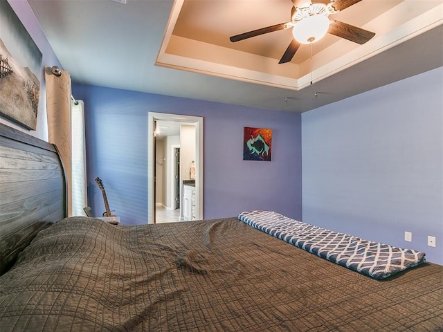 bedroom featuring a tray ceiling and ceiling fan