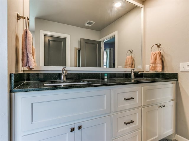 full bathroom with a sink, visible vents, and double vanity