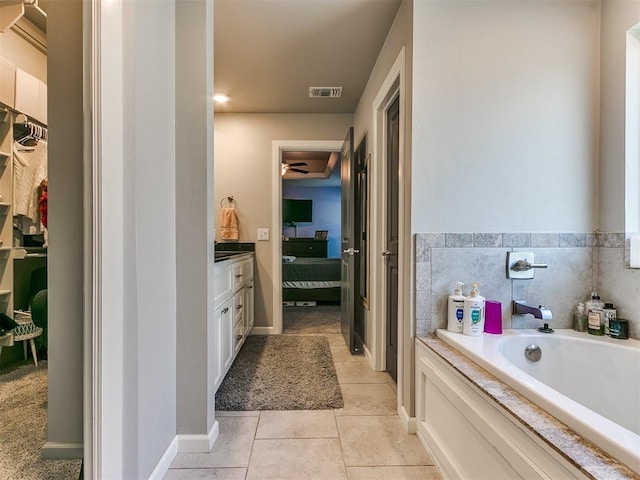 ensuite bathroom featuring visible vents, baseboards, a garden tub, ensuite bathroom, and tile patterned floors