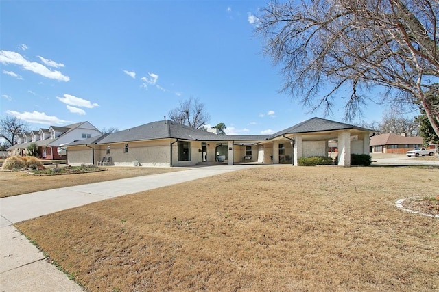 view of front of house with a front lawn and concrete driveway