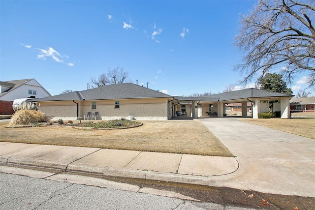 view of front of home featuring an attached carport and driveway