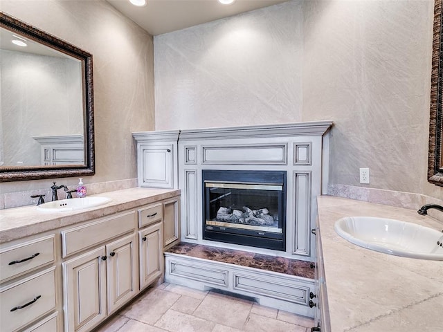 bathroom with a glass covered fireplace and vanity