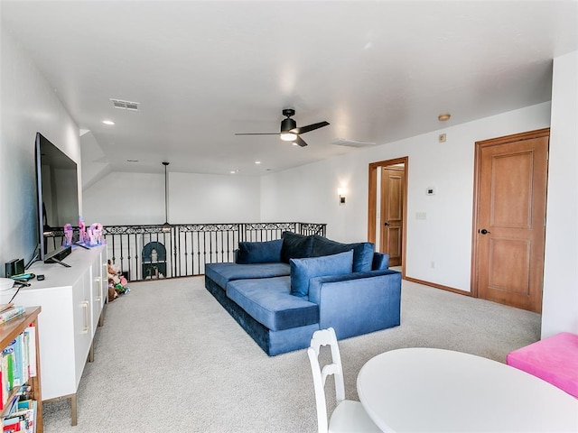 living room with light carpet, visible vents, and a ceiling fan