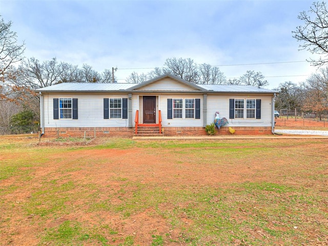 ranch-style home with a front yard, crawl space, metal roof, and entry steps