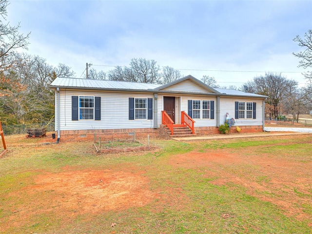 single story home featuring entry steps, metal roof, a front lawn, and crawl space