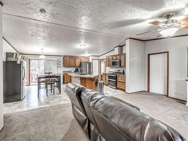 living area with ornamental molding, light colored carpet, visible vents, and a textured ceiling