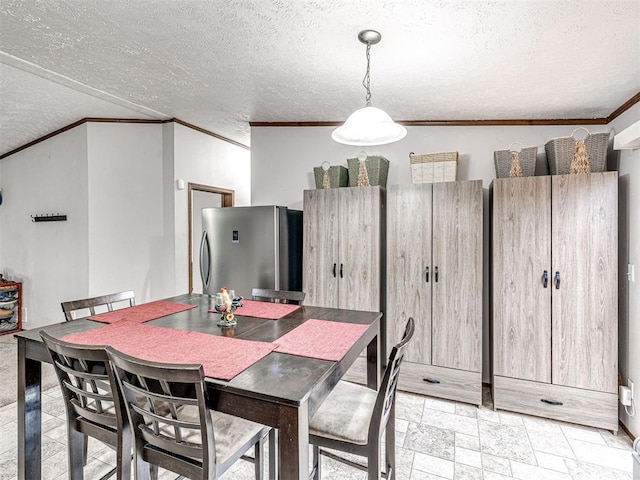 dining space with ornamental molding and a textured ceiling