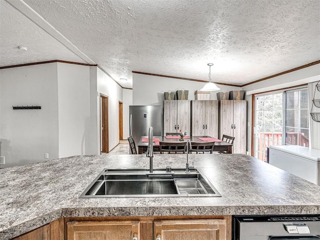 kitchen with a sink, ornamental molding, stainless steel refrigerator, and dishwasher