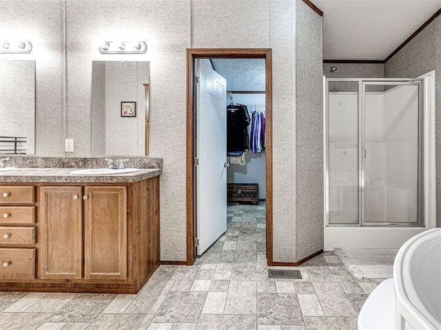 full bath featuring a textured ceiling, a washtub, a sink, visible vents, and a shower with door