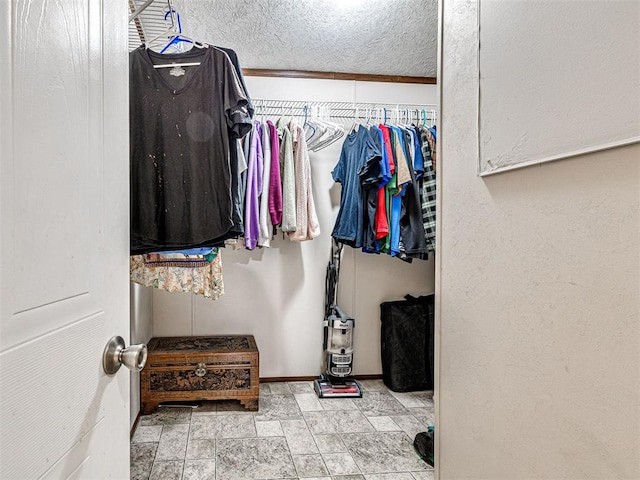 walk in closet with stone finish flooring