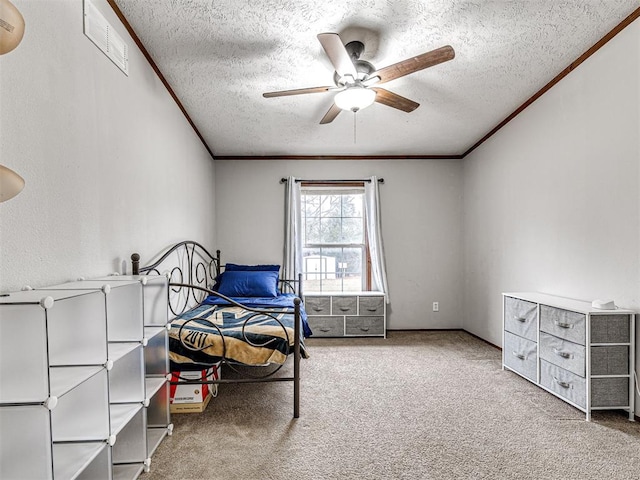 carpeted bedroom featuring visible vents, crown molding, and a textured ceiling