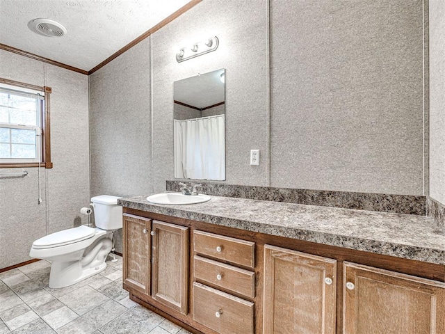 full bath with visible vents, toilet, vanity, a textured ceiling, and crown molding