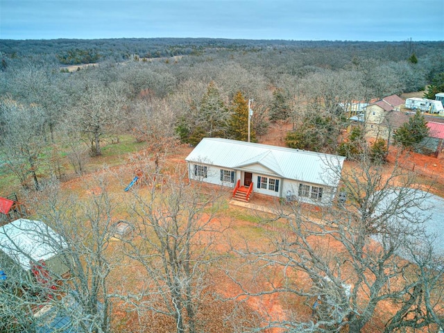 aerial view featuring a wooded view