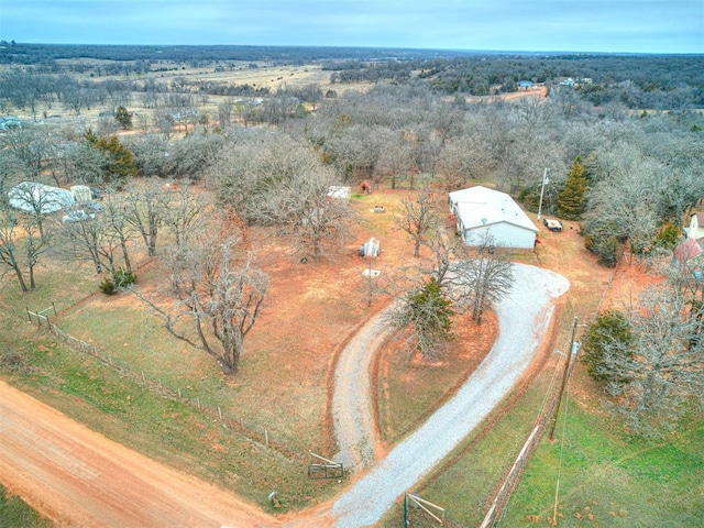 drone / aerial view with a wooded view