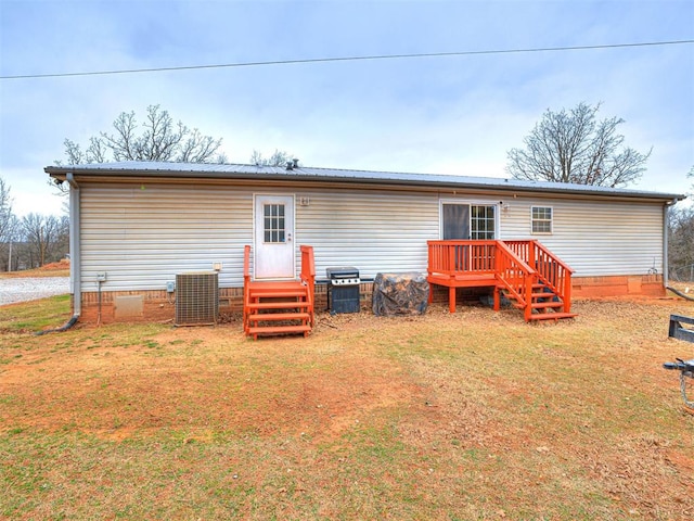 back of house featuring crawl space, metal roof, cooling unit, and a yard