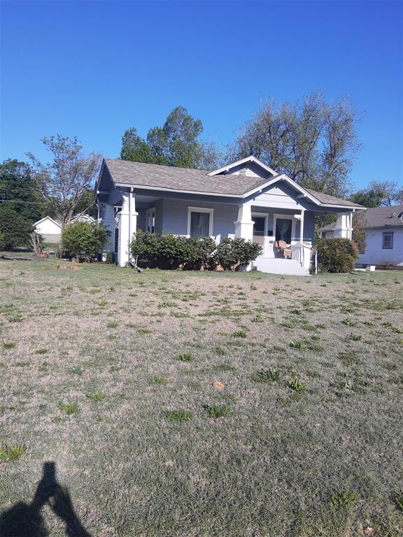 bungalow-style house with a porch and a front lawn
