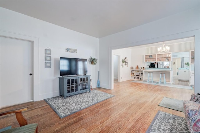 living area featuring wood finished floors and a notable chandelier