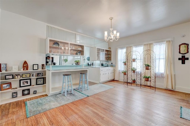 entrance foyer featuring an inviting chandelier and light wood-style floors