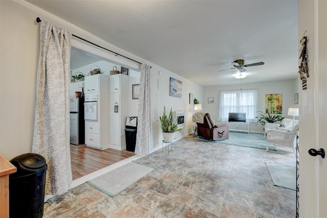 hall with stone finish flooring and baseboards