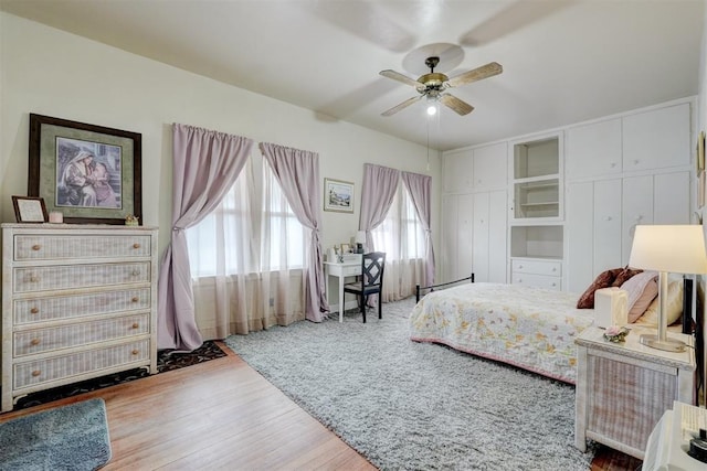 bedroom with a ceiling fan and wood finished floors