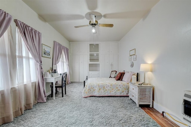 bedroom with a ceiling fan and heating unit