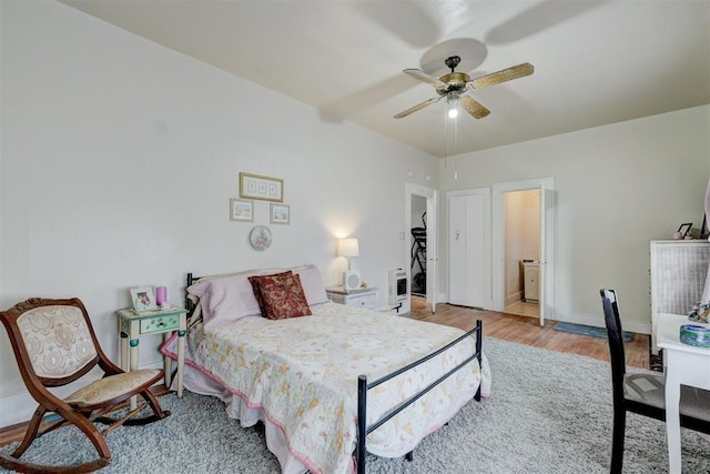 bedroom with baseboards, wood finished floors, and ceiling fan