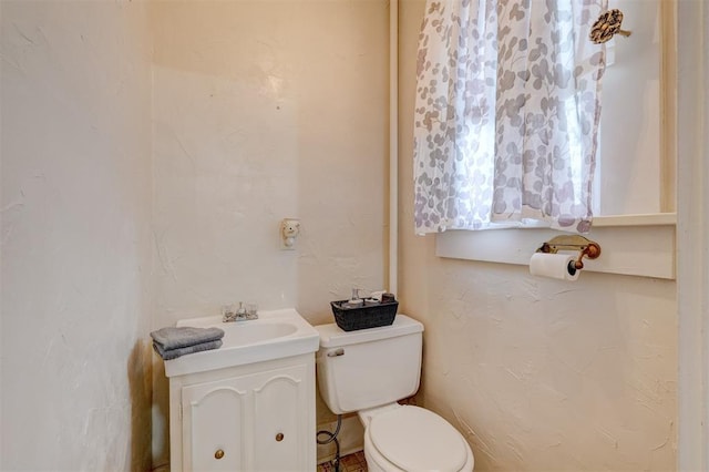 half bathroom featuring a sink and toilet