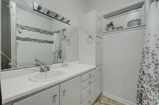 bathroom featuring a shower with curtain, baseboards, and vanity