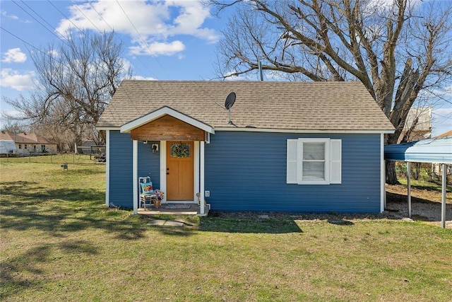 bungalow-style home with a shingled roof and a front lawn