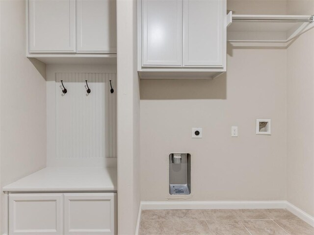 washroom with hookup for a washing machine, cabinet space, electric dryer hookup, baseboards, and tile patterned floors