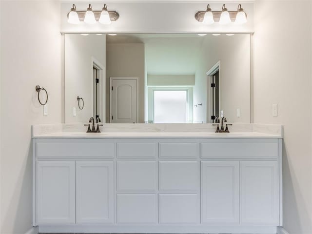 full bathroom featuring double vanity and a sink