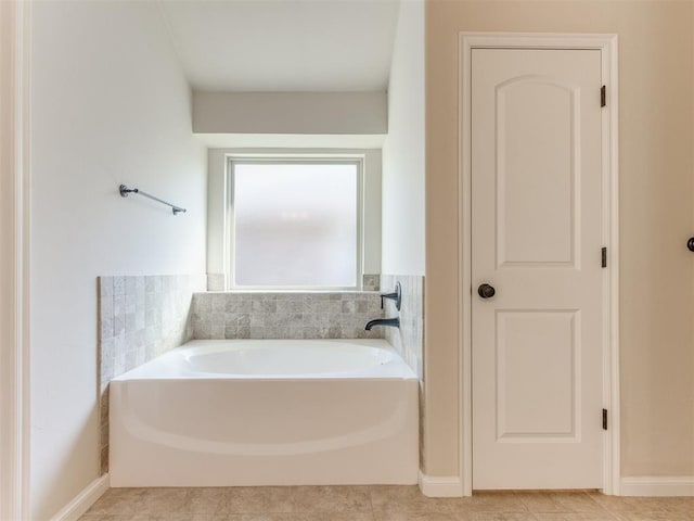 full bathroom featuring tile patterned flooring and a bath