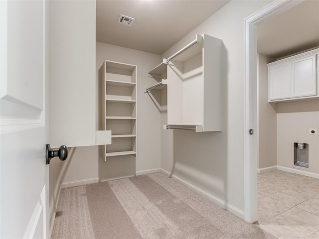 spacious closet featuring light tile patterned floors and visible vents