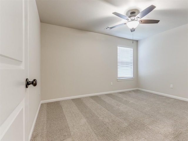 empty room with carpet floors, baseboards, and a ceiling fan