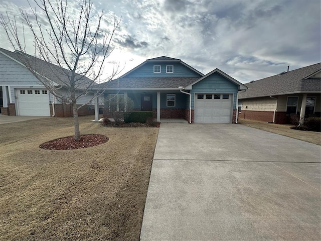 view of front of property with brick siding, a porch, roof with shingles, a garage, and driveway