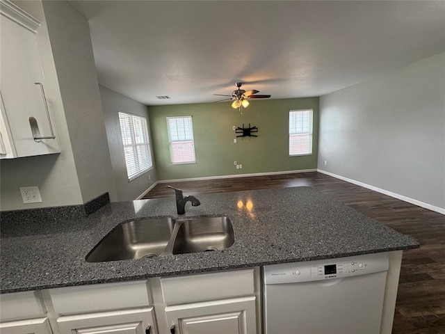 kitchen featuring open floor plan, white cabinets, white dishwasher, and a sink