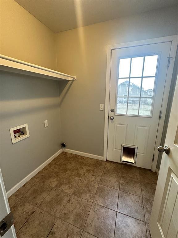 laundry area featuring laundry area, hookup for a washing machine, baseboards, and tile patterned floors