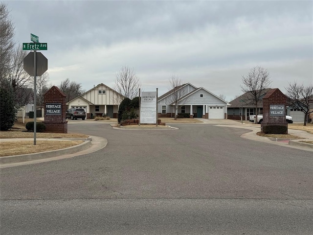 view of street featuring traffic signs, curbs, and sidewalks